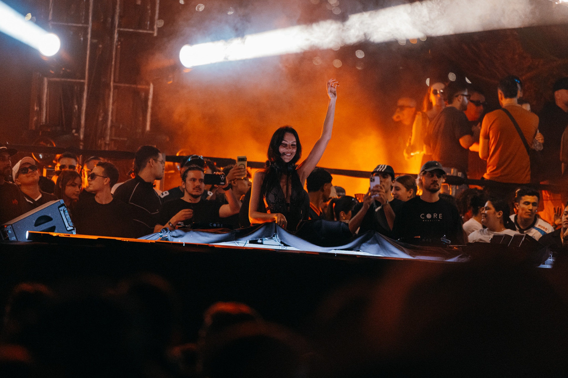 DJ in front of an orange-lit crowd at CORE Melbourne